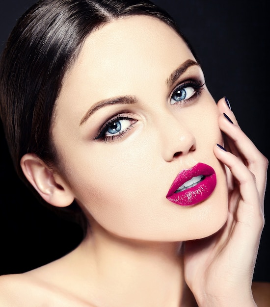 Caucasian young woman model with bright makeup, perfect clean skin and colorful pink lips