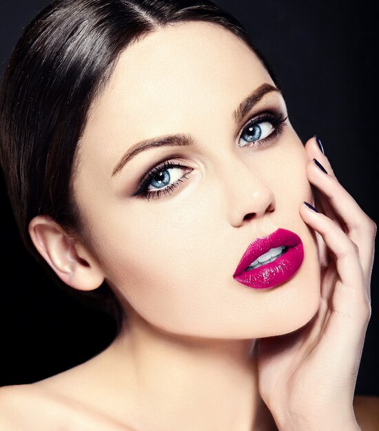 Caucasian young woman model with bright makeup, perfect clean skin and colorful pink lips