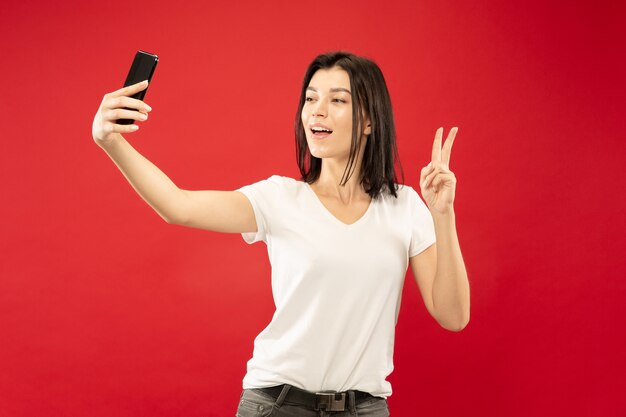 Caucasian young woman's half-length portrait. Beautiful female model in white shirt