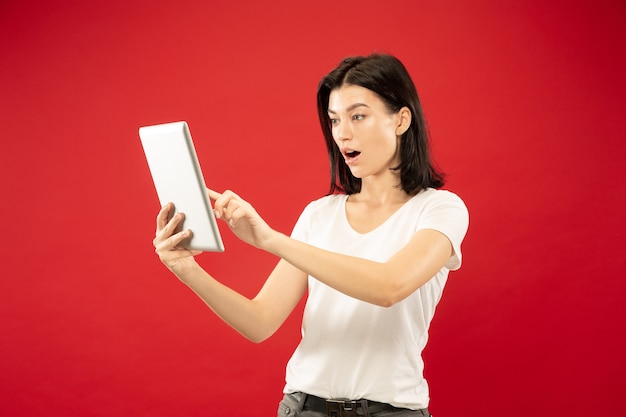 Caucasian young woman's half-length portrait. Beautiful female model in white shirt