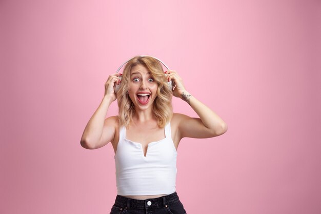 Caucasian young woman's portrait isolated on pink studio