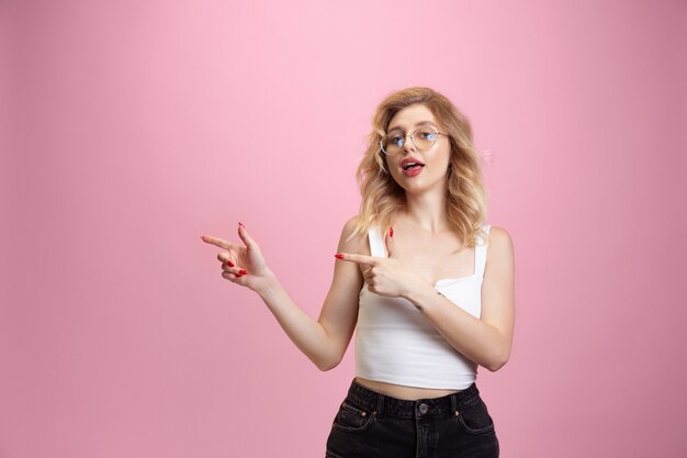 Caucasian young woman's portrait isolated on pink studio