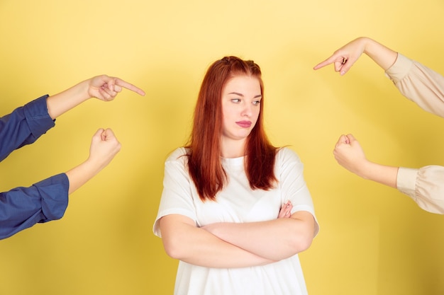 Free photo caucasian young woman's portrait on yellow background, too much tasks