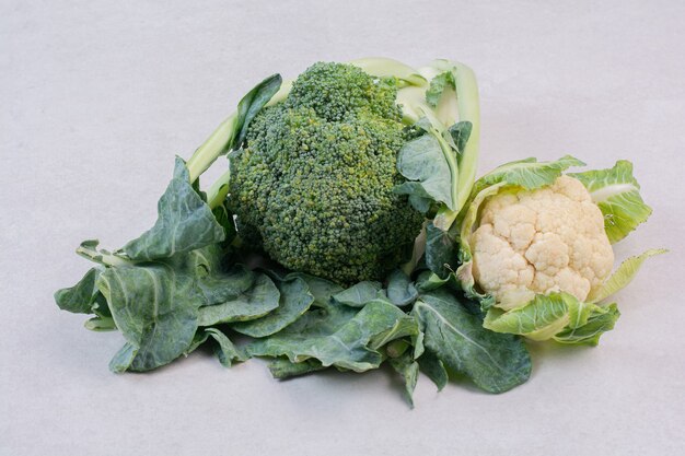 Cauliflower and broccoli on white surface
