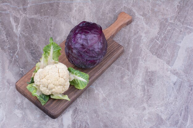 Cauliflower and cabbage isolated on marble surface