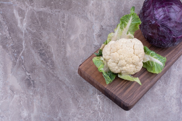 Cauliflower and cabbage isolated on marble surface