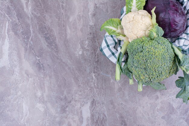 Cauliflower and cabbage isolated on marble surface