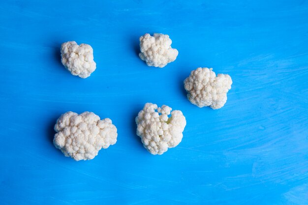 Cauliflower on a cyan blue background. top view.