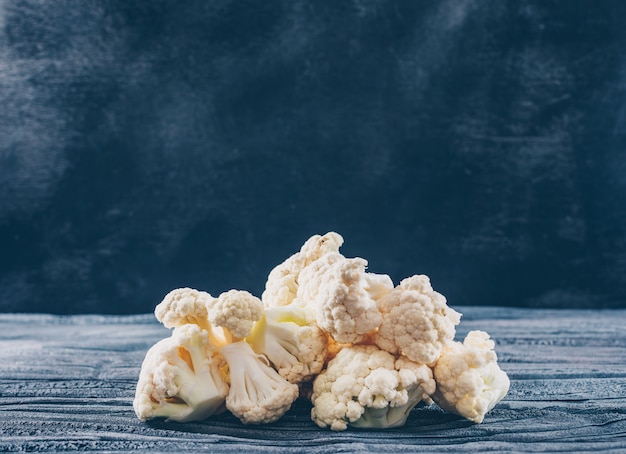 Cauliflower side view on a dark wooden background free. space for your text