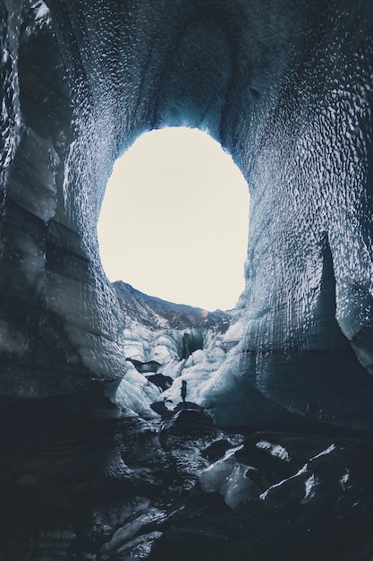 Cave with snow during daytime