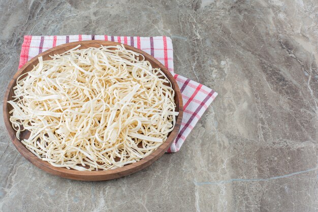 Cecil cheese in a bowl on burlap napkin on marble.