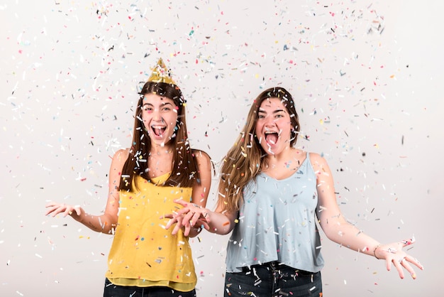 Free photo celebration concept with two delighted girls