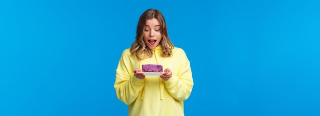 Celebration party and lifestyle concept happy and pleased blond caucasian girl in yellow hoodie look