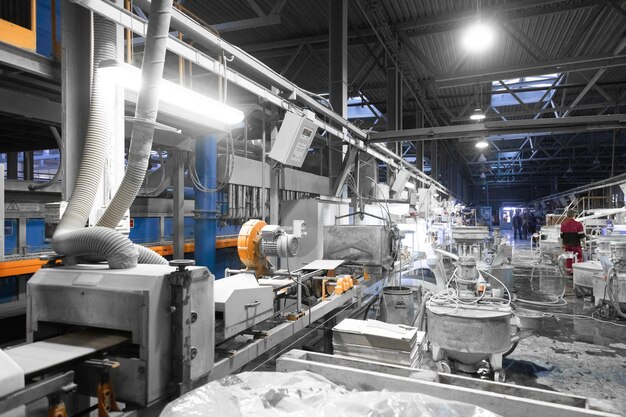 Cement factory interiors Industrial cement production conveyor Workers in the shop on the production line