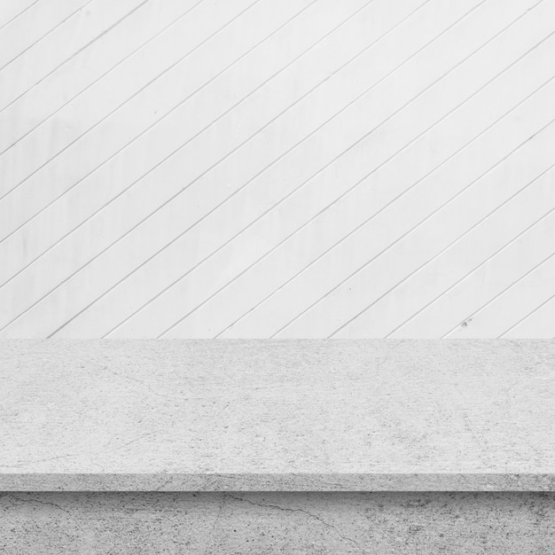 Cement floor with wall of white wooden boards