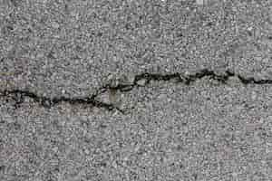 Free photo cement surface with rocks and crack