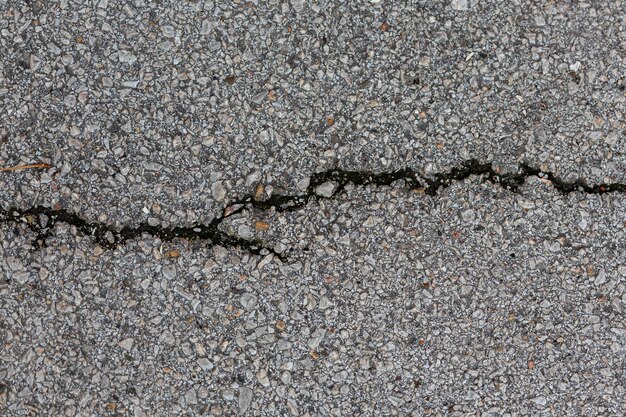 Cement surface with rocks and crack