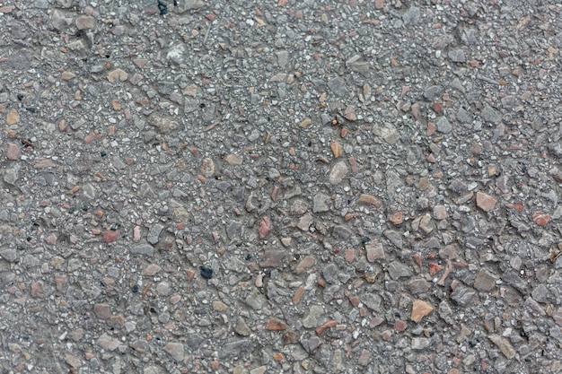 Free photo cement surface with rocks and pebbles