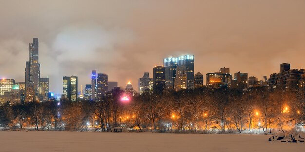 Central Park winter at night panorama with skyscrapers in midtown Manhattan New York City