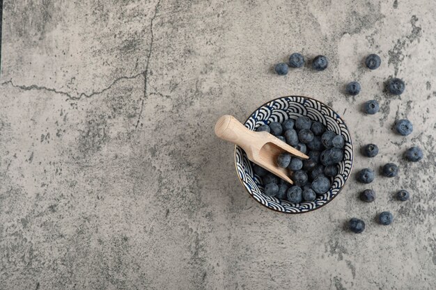 나무 숟가락으로 맛있는 신선한 블루베리 세라믹 그릇