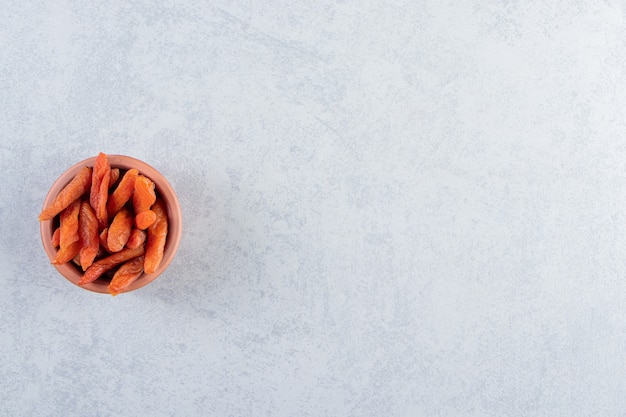 Ceramic bowl with delicious dried fruits on stone.