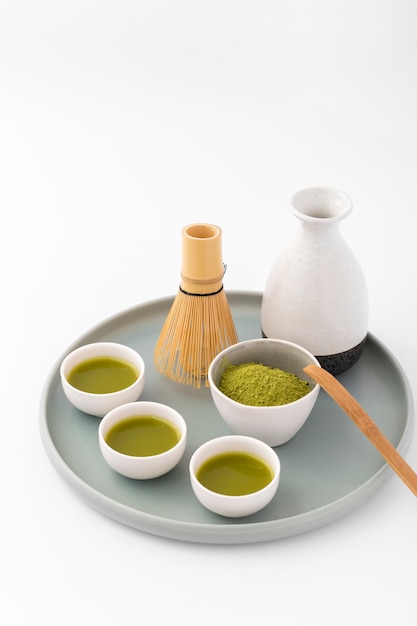 Ceramic cups with matcha tea on a tray