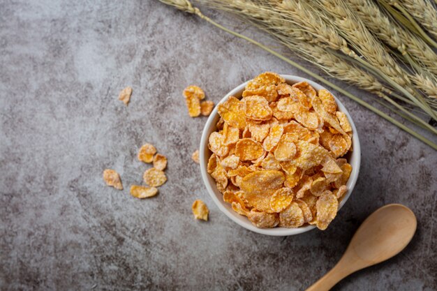 Cereal in bowl and milk on dark background