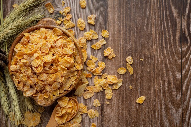 Cereal in bowl and milk on dark wooden background