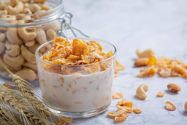 Cereal in bowl and milk on marble background