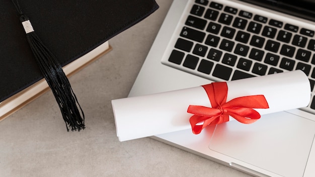 Certificate with ribbon and bow and laptop
