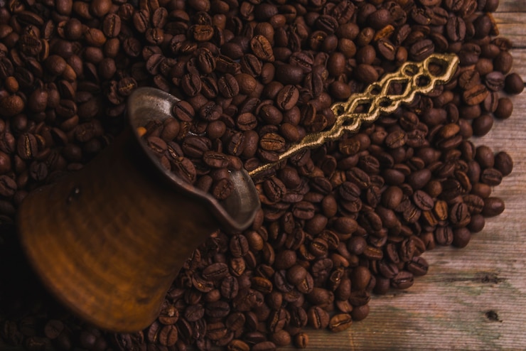 Free Photo cezve on coffee beans