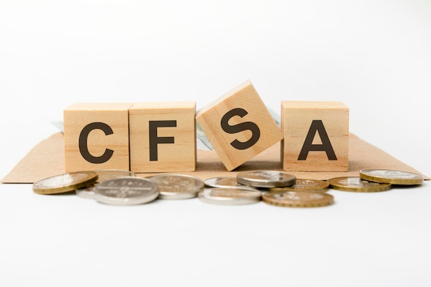 木製​の​ブロック​に​書かれた​cfsa​の​単語​。​ビジネス​コンセプト​。​フロント​フィールド​の​コイン​。​ビジネス​コンセプト