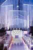 Free photo chairs in wedding hall and wedding ceremony venue in white and violet