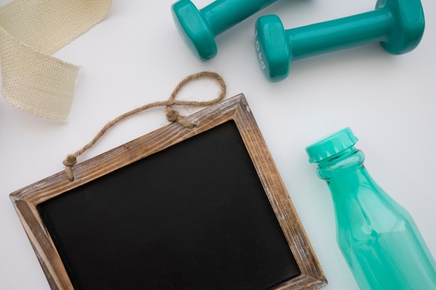 Chalkboard, bottle and dumbbells