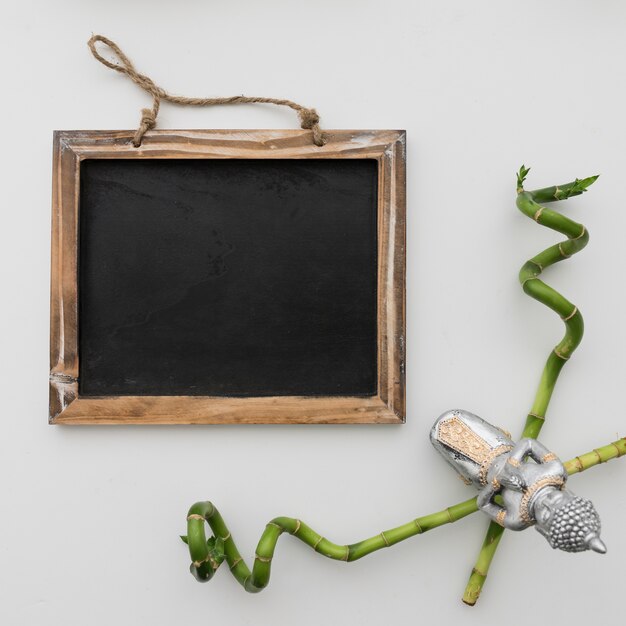 Chalkboard and buddha with bamboo sticks