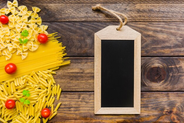 Chalkboard near pasta ingredients