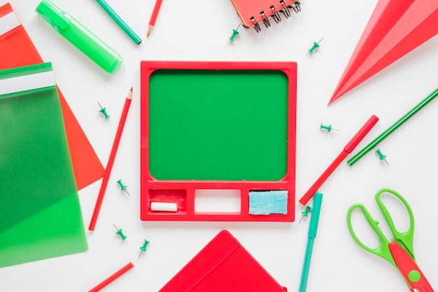 Chalkboard surrounded by writing objects