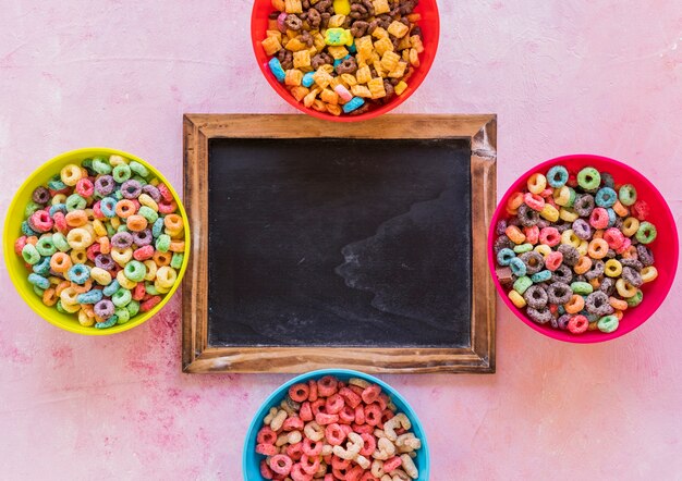 Chalkboard with bowls of cereals on table 