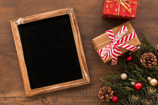 Chalkboard with Christmas gift boxes on table 