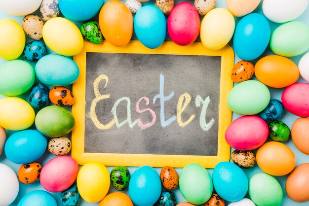 Chalkboard with Easter title between set of colored eggs