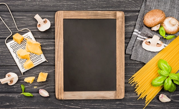 Chalkboard with ingredients for spaghetti with mushrooms