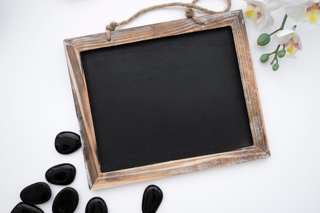 Chalkboard with stones and flower