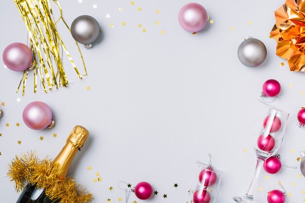 Champagne bottle with baubles on table