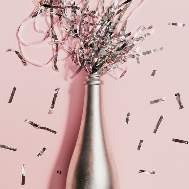 Champagne bottle with confetti at new years party