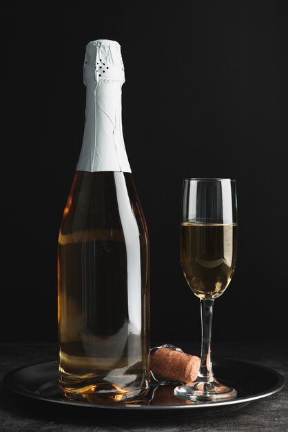 Champagne bottle with glass on a tray