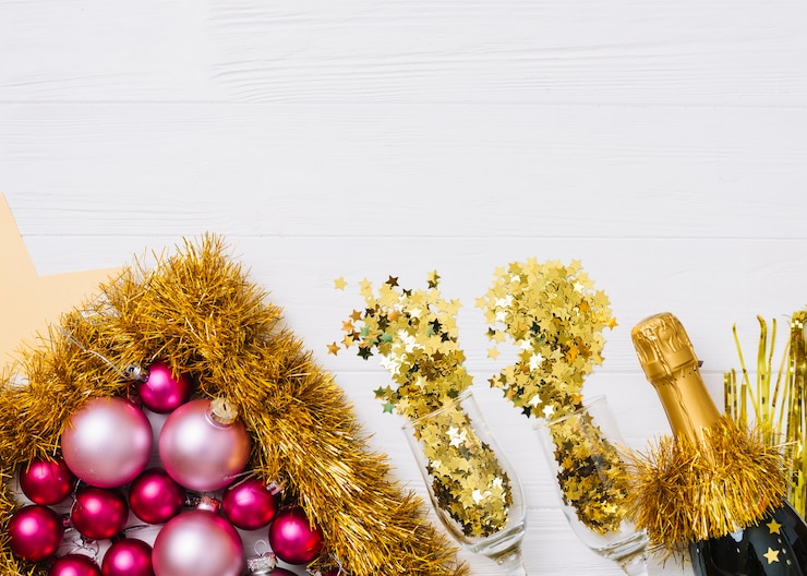 Free Photo champagne bottle with shiny baubles on table
