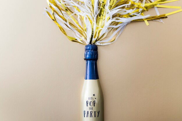 Champagne bottle with tinsel on table 