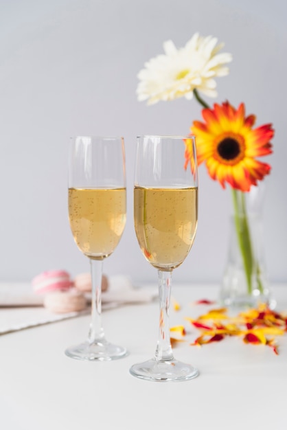 Champagne glasses surrounded by fowers