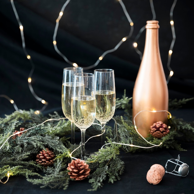 Champagne glasses with branches on table 