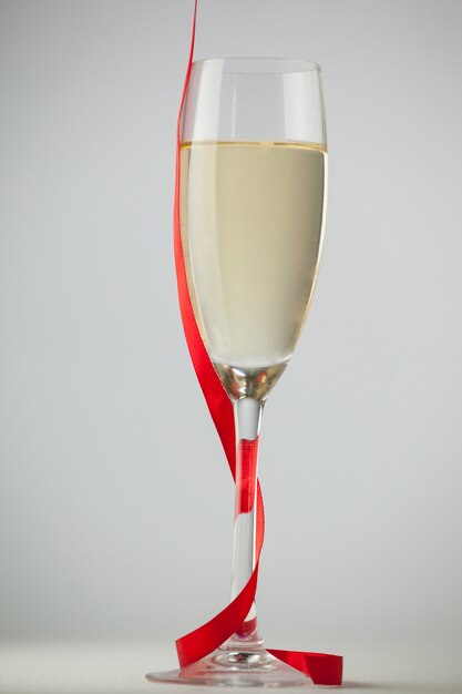 Free photo champagne glasses with a red ribbon